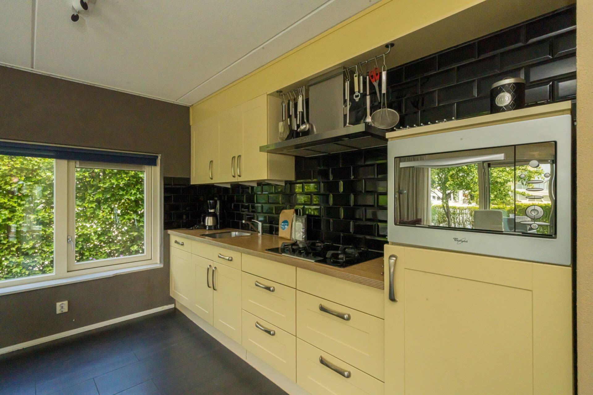 A modern kitchen with a stove, sink, and cabinets.