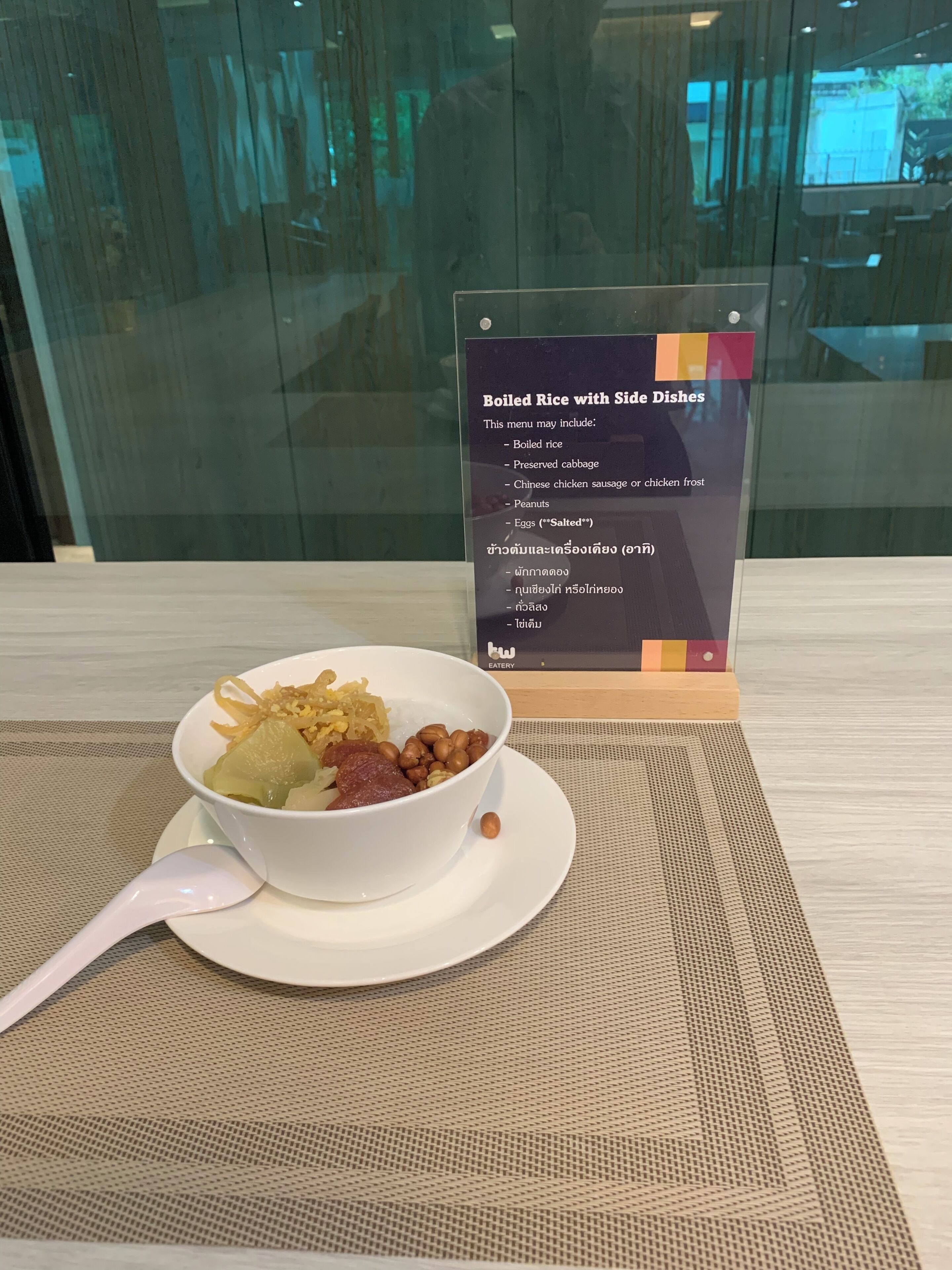 A bowl of food with a menu sign in the background.