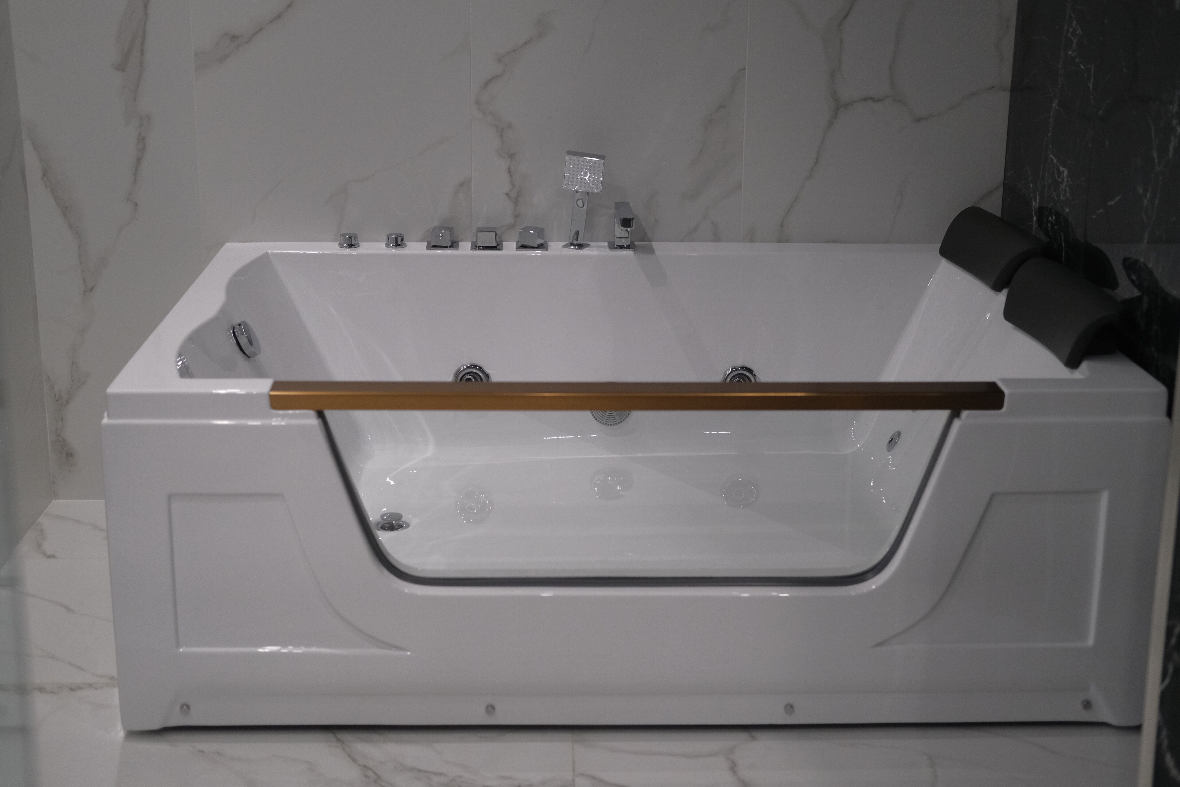 A white bathtub with a wooden handle, a showerhead, and a control panel.