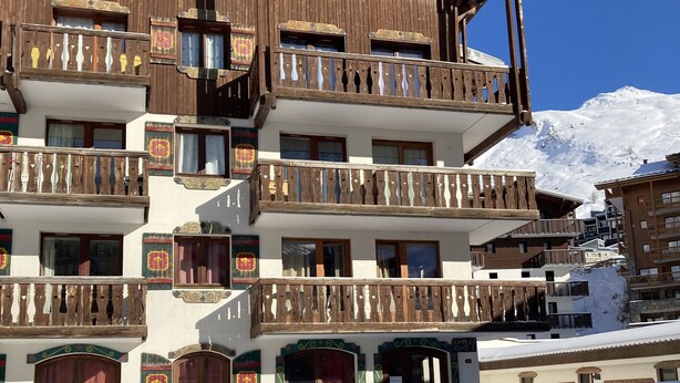A multi-story wooden building with balconies and a snow-covered ground. - Tignes, Val Claret - at the centre of the Tignes and Val d'Isere ski area. (Tignes)