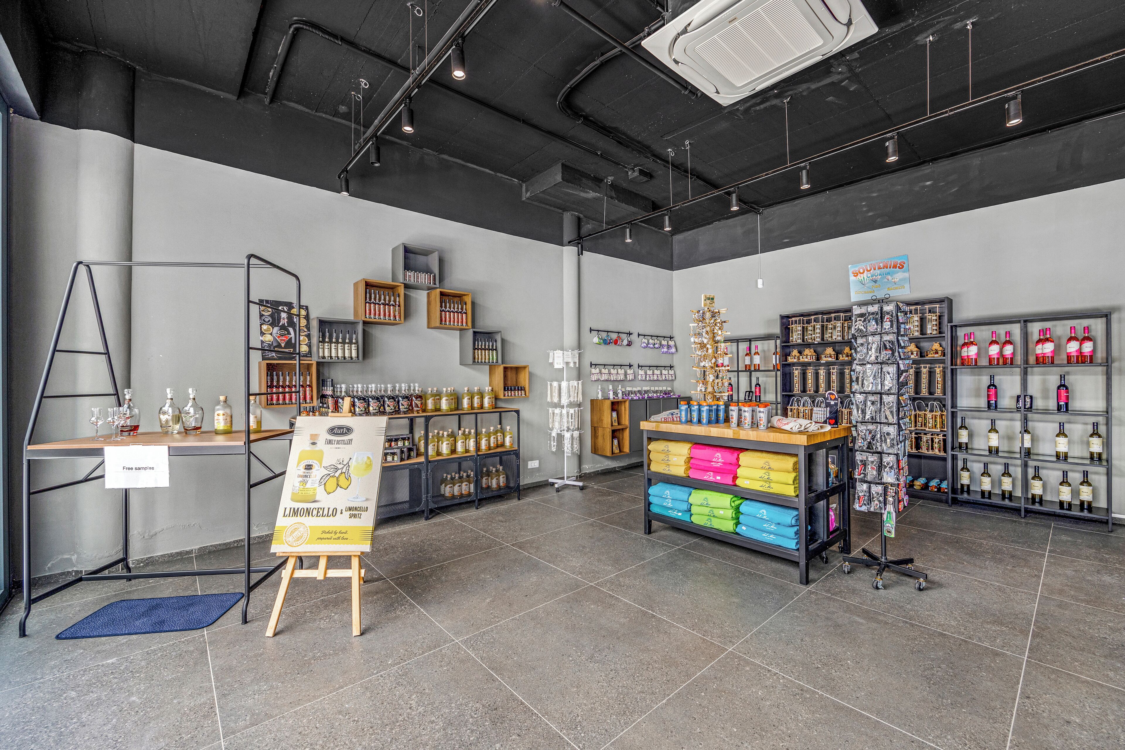 A modern retail space with shelves of products, a display table, and a signboard.