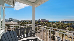 A balcony with a view of a beach and buildings. - Newly Built Condo w/ 3 Pools & Steps to Beach + Free Attraction Tickets! (Santa Rosa Beach)