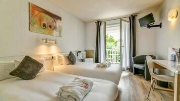 A hotel room with two beds, a desk, a chair, a TV, and a balcony with curtains.
