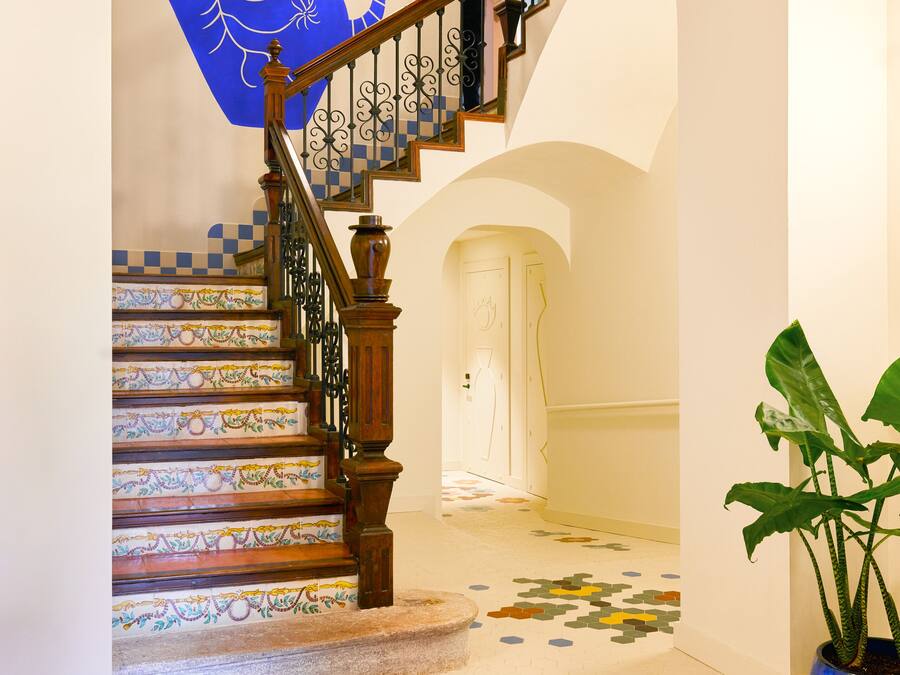 A staircase with ornate railings and a patterned floor.