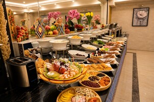 A buffet with various food items and a toaster.