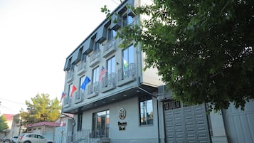 Hotel with a modern design, featuring a balcony and international flair.