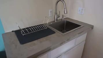 Fridge, coffee/tea maker, cookware/dishes/utensils, paper towels