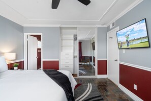 Relax in a stylish room with a large bed, flat-screen TV, and a separate seating area.
