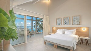 A modern bedroom with a large bed, a balcony with a view, and three framed artworks on the wall. - The 5 Tangarane apartments are located in Les Trois Ilets, overlooking the magni (Les Trois-Îlets)