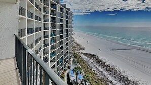 A high-rise hotel with multiple balconies overlooking a beach. - Edgewater Tower III #911 | Beachfront + Amenities! (Panama City Beach)