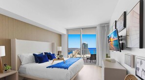 A modern hotel room with a large bed, a city view balcony, and artwork on the walls. - Insane Ocean View Balcony Beachfront Resort Pool (Hollywood)