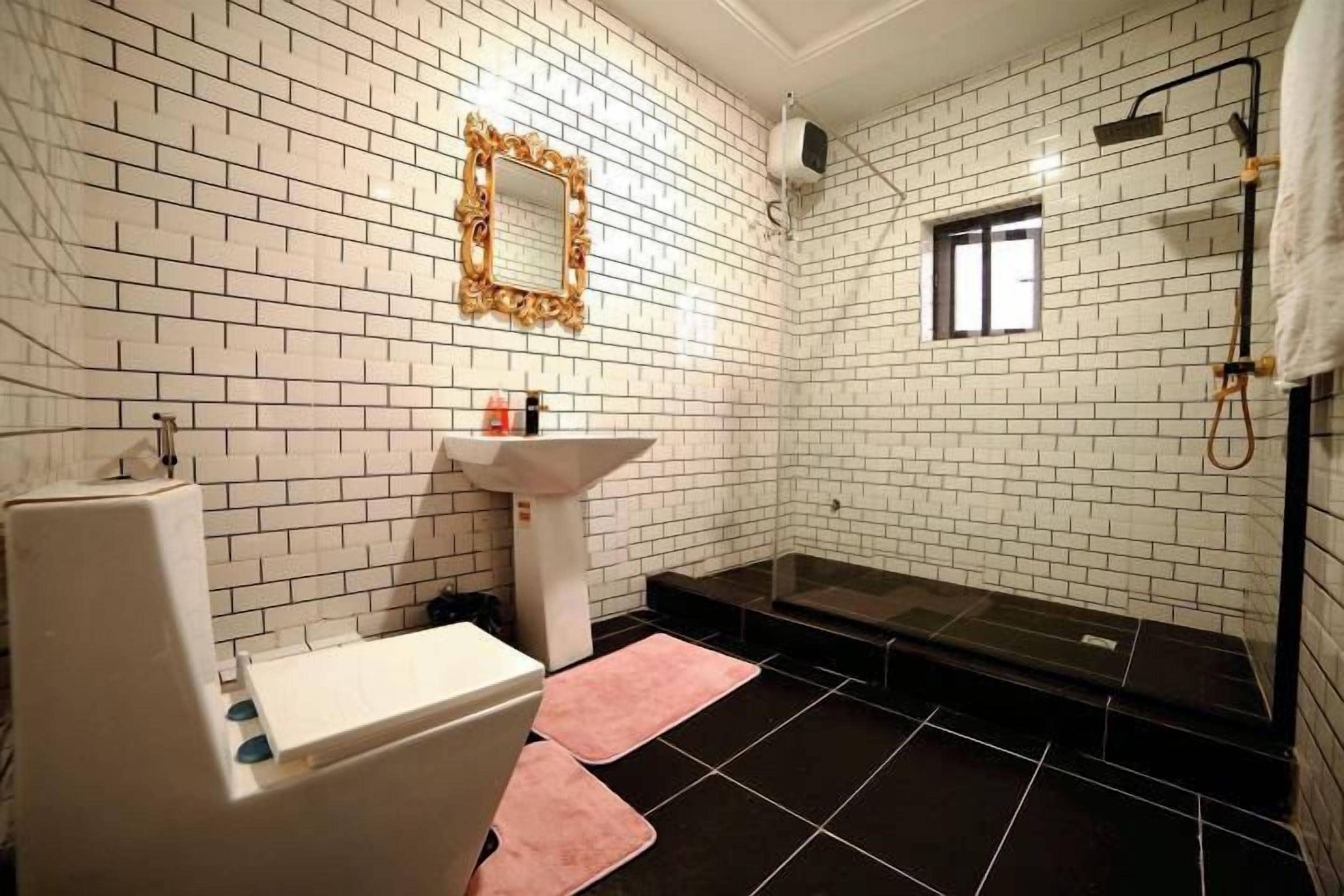 A bathroom with white brick walls, a white sink, a mirror, a shower, and a bathtub.