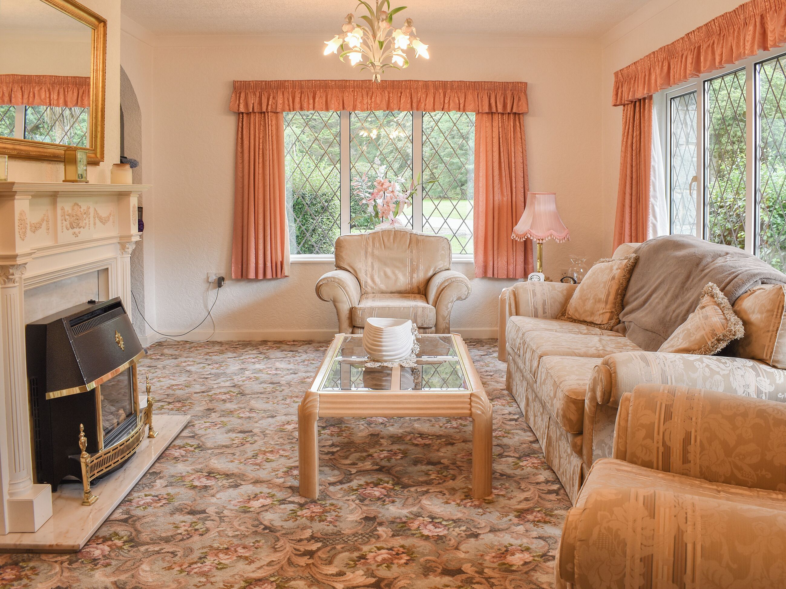 A living room with a fireplace, a sofa, a chair, and a coffee table.