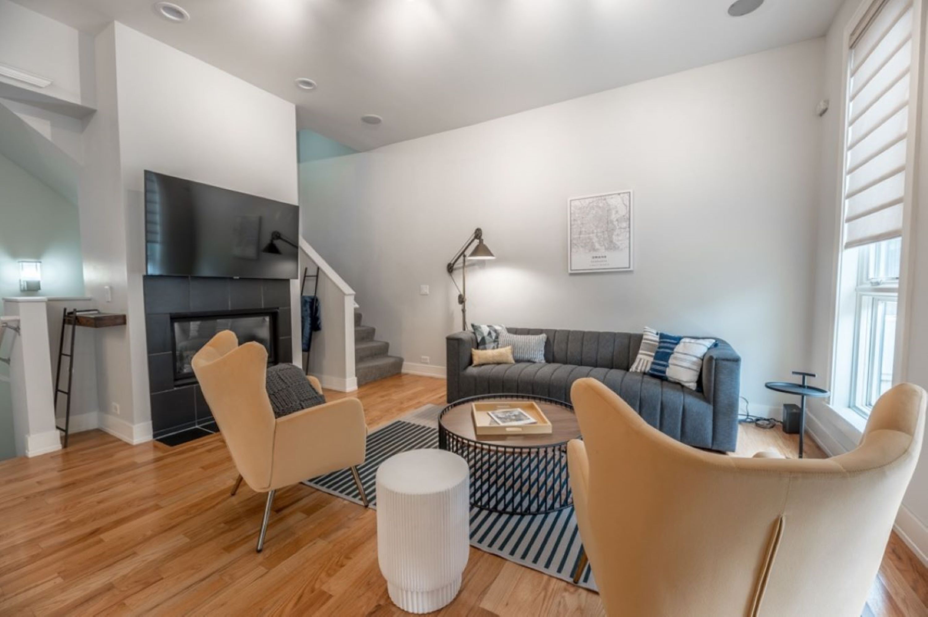 A modern living room with a fireplace, a sofa, and a coffee table.