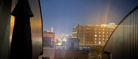 A nighttime cityscape with buildings and a silhouette of a person.