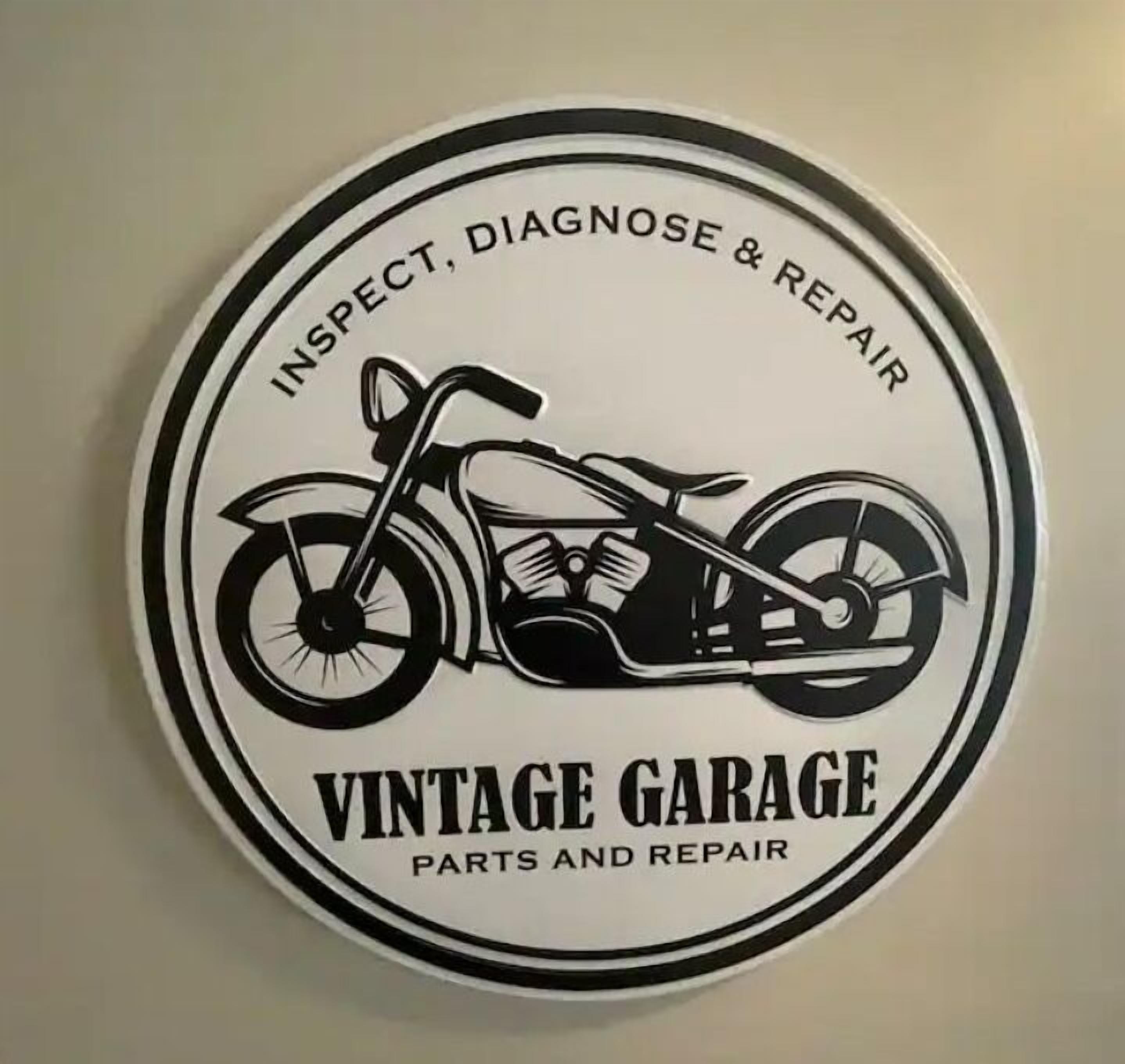 A circular sign with a motorcycle and text reading "INSPECT, DIAGNOSE & REPAIR VINTAGE GARAGE PARTS AND REPAIR."