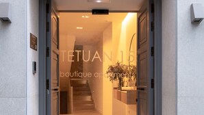 A modern boutique hotel entrance with a staircase leading to the upper floor. - Hommyhome Tetuán 15 Boutique - 202 (Sevilla)