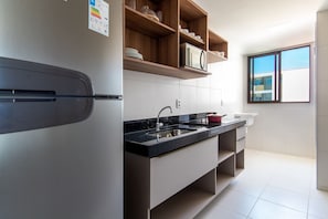 Apartment | Private kitchen | Fridge, microwave, stovetop, cookware/dishes/utensils