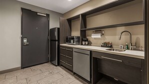 A modern kitchen with a refrigerator, microwave, coffee maker, and sink. - Home2 Suites By Hilton Cookeville (Cookeville)