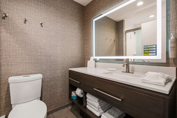 A modern bathroom with a toilet, a sink with a mirror, and a towel rack. - Home2 Suites By Hilton Cookeville (Cookeville)
