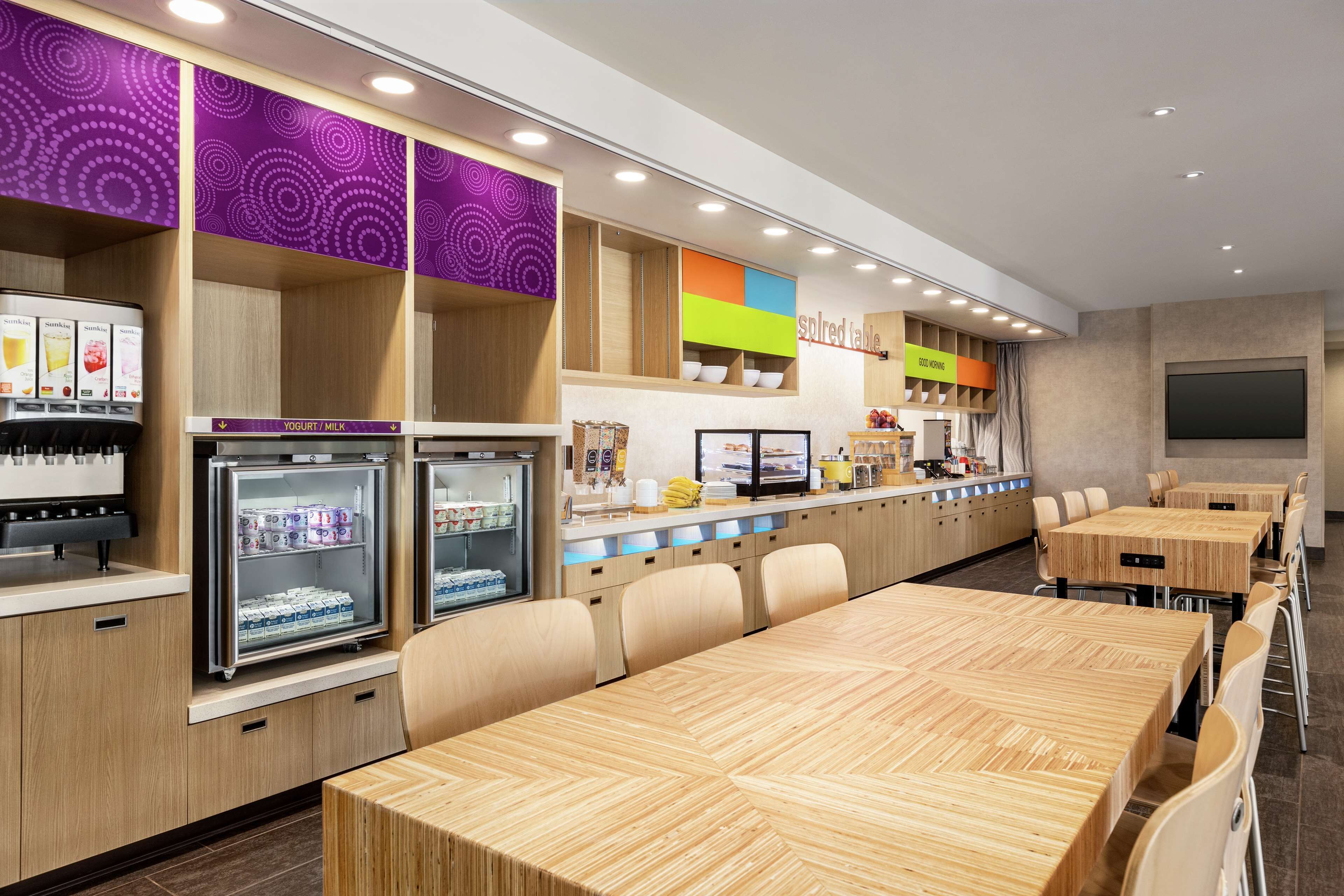 A modern café with seating and a counter area.