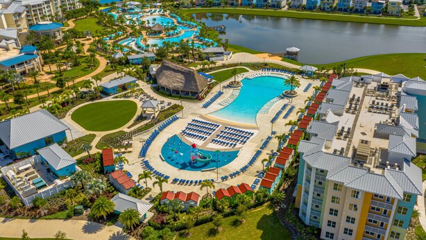 A resort with multiple swimming pools, a large central pool, and a variety of guest accommodations. - Embassy Suites By Hilton Orlando Sunset Walk (Kissimmee)