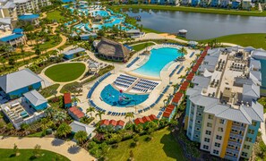 A resort with multiple swimming pools, a large central pool, and a variety of guest accommodations. - Embassy Suites By Hilton Orlando Sunset Walk (Kissimmee)