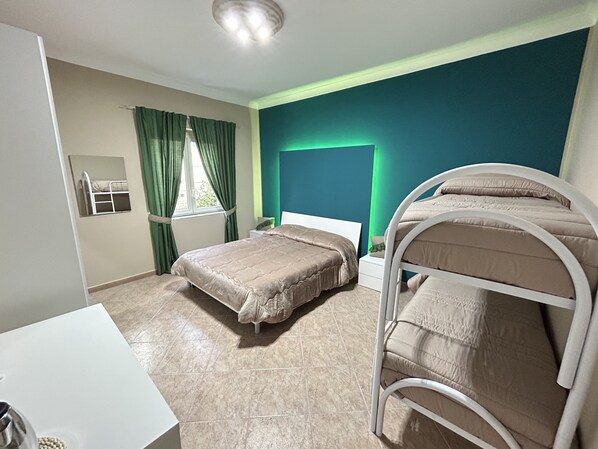 A room with two beds, a desk, and a window with curtains. - Skycity b&b (Naples)