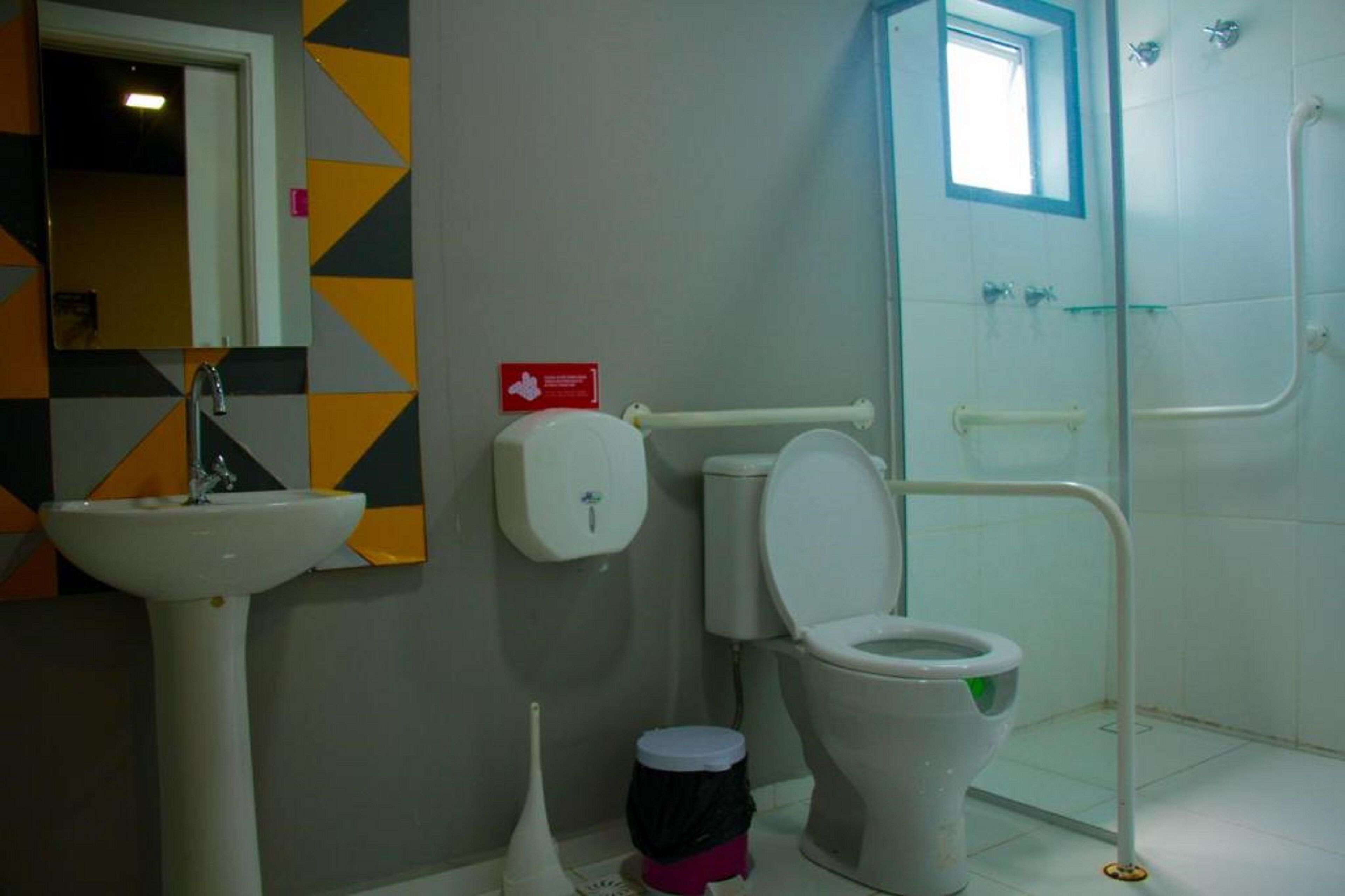 A bathroom with a sink, toilet, and shower.