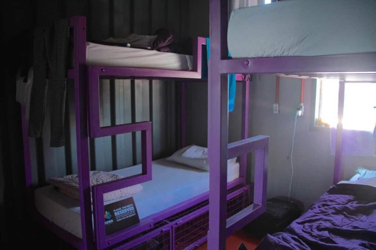 A bunk bed room with a sign on the lower bunk bed.