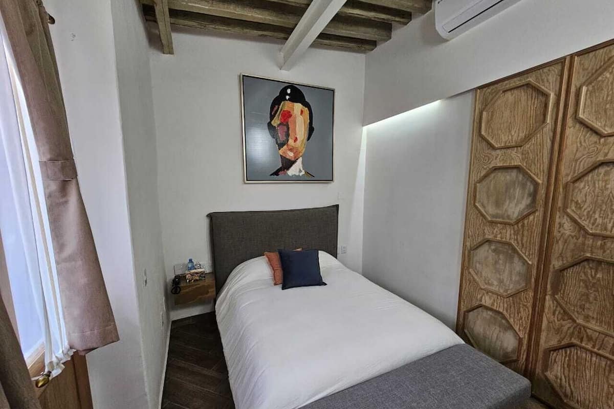 Comfort Room | Down comforters, desk, laptop workspace, blackout drapes