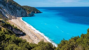 A coastal landscape with a beach, cliffs, and clear blue sea. - Villa Dalula in Agios Nikitas (Lefkada)
