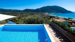 A swimming pool with a view of a coastal town and mountains. - Villa Mare 3 Aria Drakatos (Lefkada)