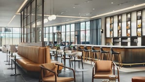 A modern bar area with seating and a bar counter.