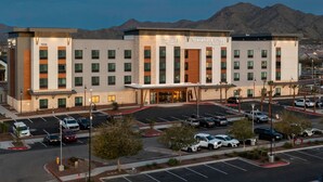 A hotel with a modern design, featuring a prominent entrance and a parking lot. - TownePlace by Marriott Suites Buckeye Verrado (Buckeye)