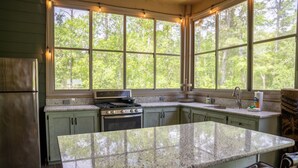 A kitchen with a large island, a stove, and a sink. - NEW LISTING ★ WATERFRONT ★ FIREPIT (Vernon)