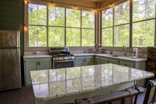 A kitchen with a large island, a stove, and a sink. - NEW LISTING ★ WATERFRONT ★ FIREPIT (Vernon)
