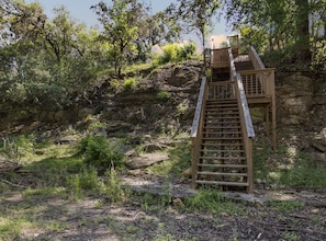 A wooden staircase leading up a rocky hillside.