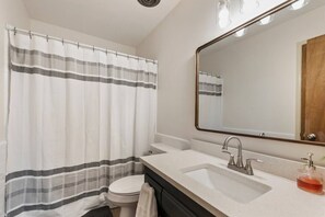 Bathtub, hair dryer, soap, shampoo