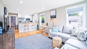 Un appartement moderne comprenant un salon, une cuisine et un coin repas.