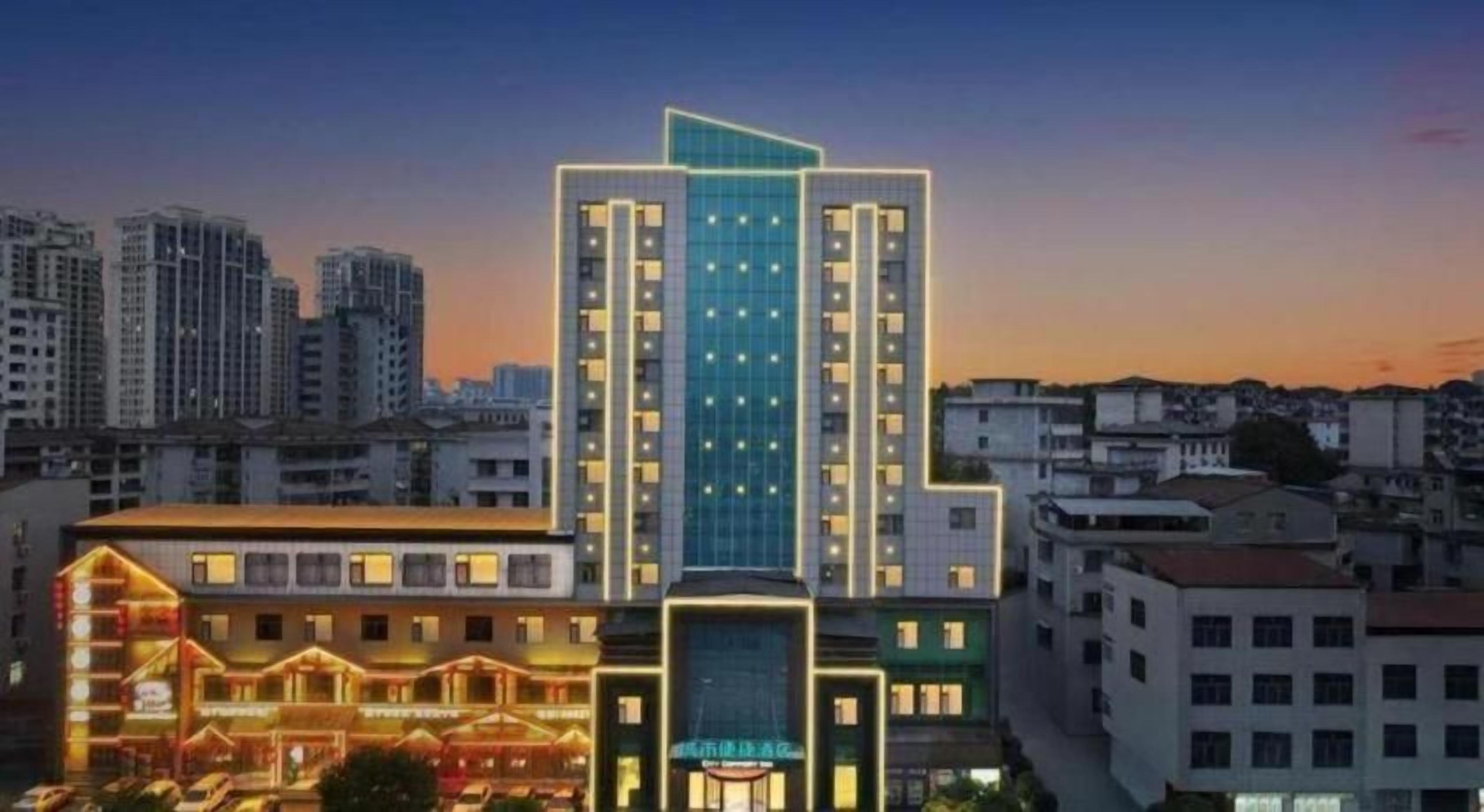 A modern high-rise hotel with multiple floors, large windows, and a prominent entrance.