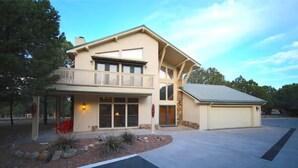 A two-story house with a balcony, a garage, and a landscaped front yard. - Let's Birdie!! (Alto)