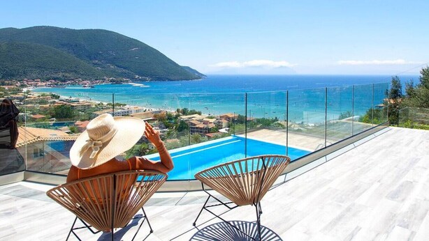 A terrace with a pool, overlooking a coastal town and the sea. - Villa Irene 1 Drakatos (Lefkada)