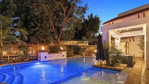 A swimming pool with a modern house in the background.