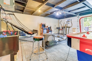Relax and stay active in this spacious room featuring a foosball table, arcade machines, and a stationary bike.