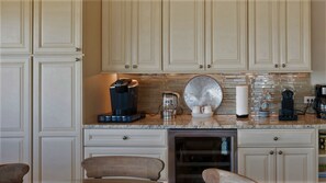 A kitchen with white cabinets, a granite countertop, and various appliances including a coffee maker and a toaster. - Villa Koki Zantos Sea View  (Zakynthos)