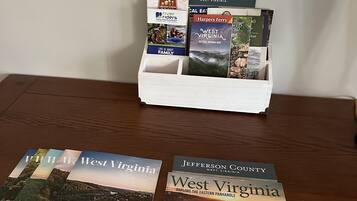 A wooden table with brochures for West Virginia and Jefferson County.