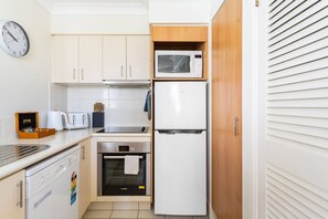 Modern kitchen with an oven, microwave, and dishwasher.