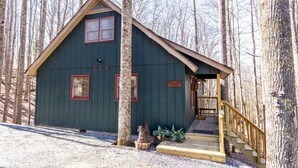 A cabin with a wooden deck and a porch, surrounded by trees. - Peaceful Cabin Near Many Activities (Beech Mountain)
