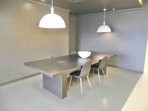 Enjoy meals and gatherings in this stylish dining area with a sleek table and comfortable chairs.